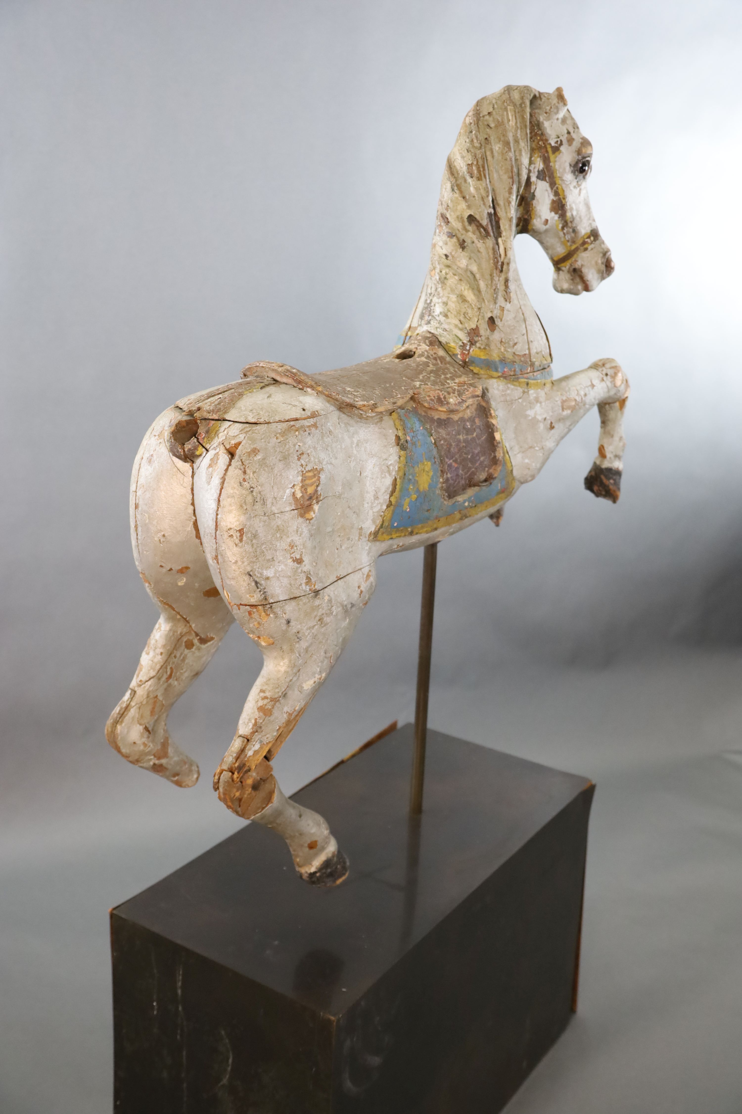 A 19th century, probably American, painted wood carousel horse, L.3ft 5in. H.3ft 7in. Overall H. when on stand 5ft 9in.